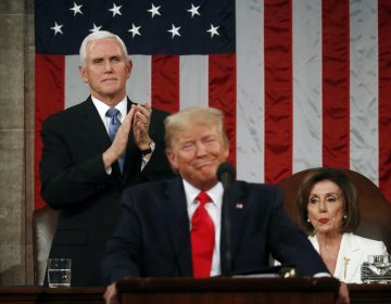 U.S. Vice President Mike Pence stands and applauds as Speaker of the House Nancy Pelosi reacts to President Donald Trump as he delivers his State of the Union address. (REUTERS/Leah Millis/POOL)