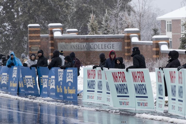 Supporters of Democratic presidential candidate former South Bend, Ind., Mayor Pete Buttigieg and Democratic presidential candidate Sen. Elizabeth Warren, D-Mass., gather outside Saint Anselm College, Friday, Feb. 7, 2020, ahead of a Democratic party debate in Manchester, N.H. (AP Photo/Matt Rourke)