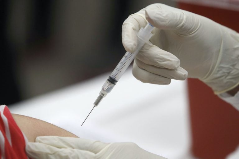 A syringe with an influenza vaccine inside heads to its mark during a flu vaccination at Eastfield College in Mesquite, Texas, Thursday, Jan. 23, 2020. (LM Otero/AP Photo)