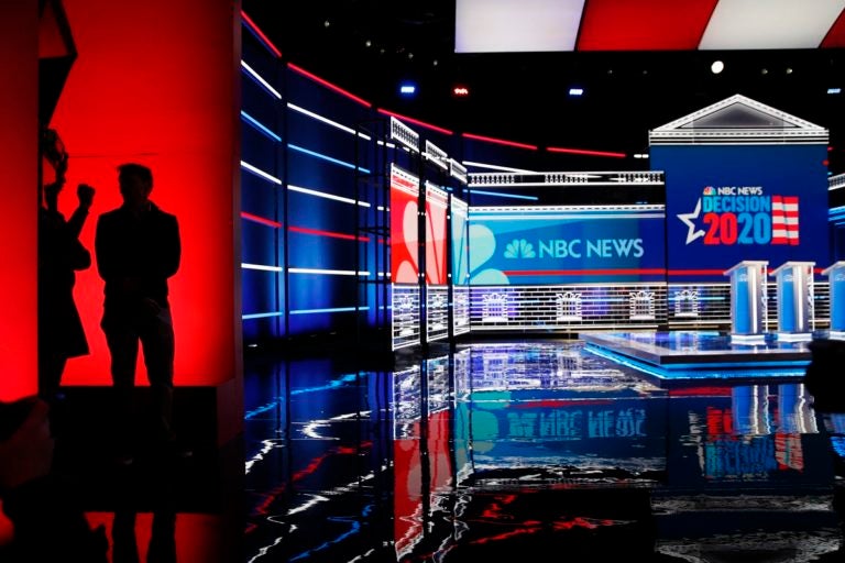 People stand on stage during setup for the Nevada Democratic presidential debate Tuesday, Feb. 18, 2020, in Las Vegas. (AP Photo/John Locher)