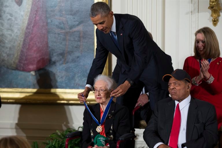 FILE-In this Tuesday, Nov. 24, 2015 photo, Willie Mays, right, looks on as President Barack Obama presents the Presidential Medal of Freedom to NASA mathematician Katherine Johnson during a ceremony in the East Room of the White House, in Washington. Johnson, a mathematician on early space missions who was portrayed in film “Hidden Figures,” died Feb. 24, 2020. (AP Photo/Evan Vucci)