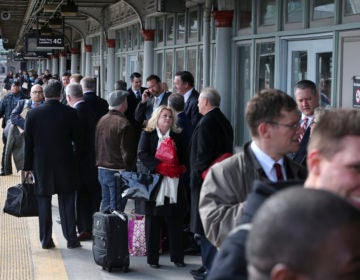 Some of the 1,000 lobbyists, business owners and politicians gather on a platform at the Trenton train station waiting to board a train to Washington, D.C., Thursday, Feb. 16, 2017 in Trenton, N.J. The state Chamber of Commerce's 80th annual trip  nicknamed the 