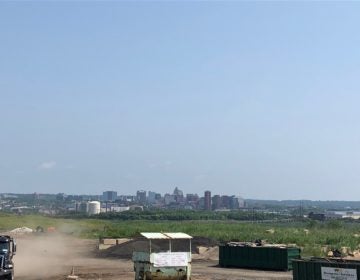 The skyline of Wilmington looms in the background of the Waste Management Inc. landfill south of the city. (Cris Barrish/WHYY)