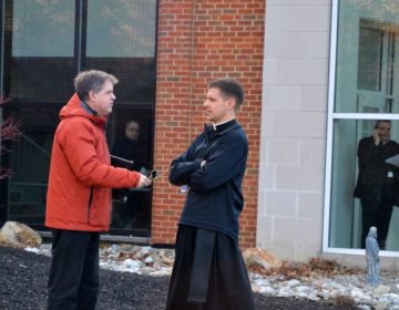 At left, the Rev. Matthew Larlick of St. Joseph’s in Berwick, Columbia County, speaks with another priest outside the Harrisburg diocese office after a meeting Wed., Feb. 19, 2020. (Brett Sholtis/WITF)