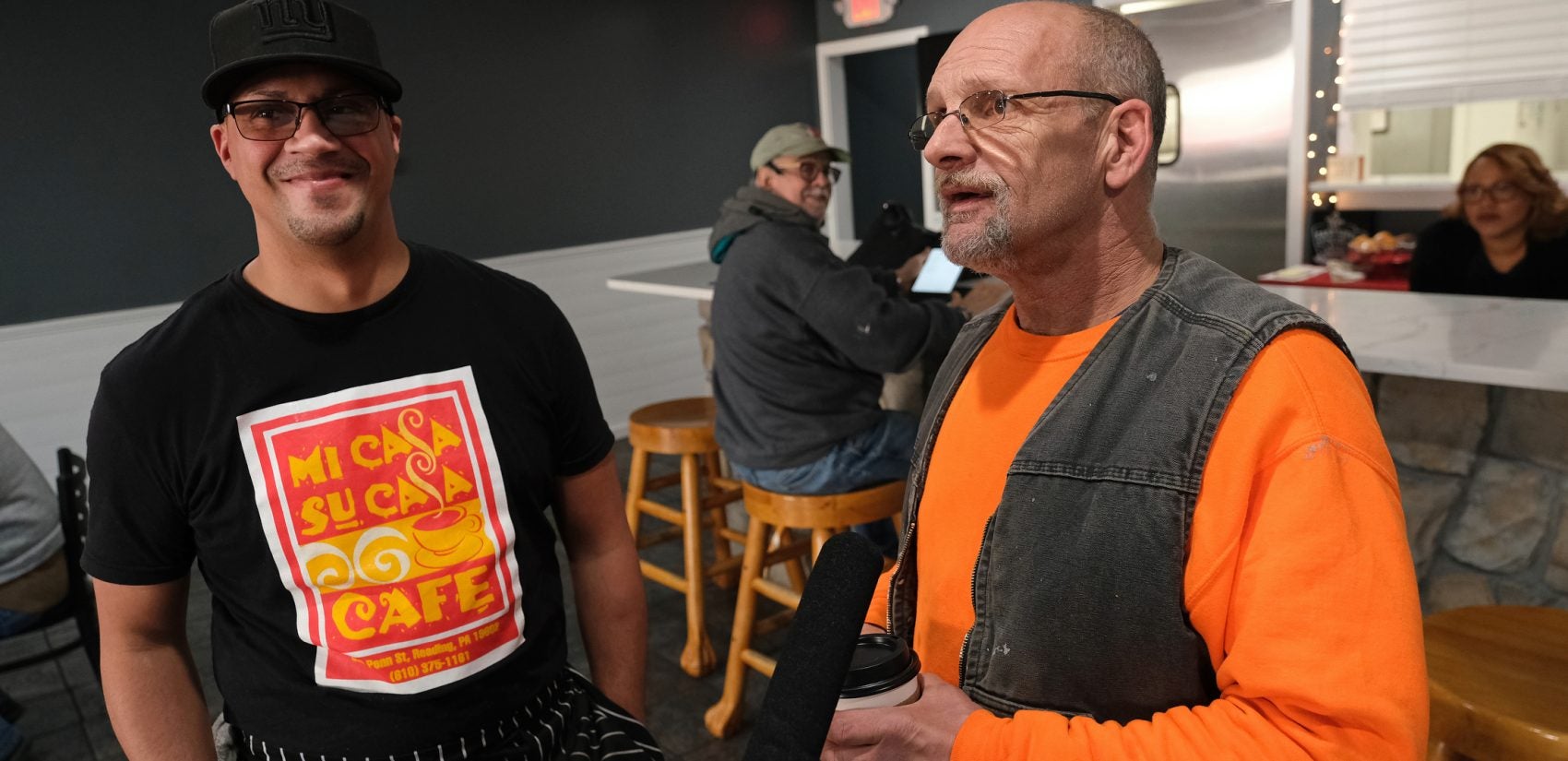 Cafe co-owner Felix Freytiz, left, talks with City of Reading employee Darrell Kauffman, right, as he stops for coffee. (Matt Smith for Keystone Crossroads)