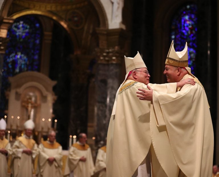 Archbishop Charles J. Chaput (left) embraces Archbishop Nelson J. Pérez (right) during his installation at the Cathedral Basilica of Saints Peter and Paul in Philadelphia on February 18, 2020. (Pool photo/ by David Maialetti/The Philadelphia Inquirer)