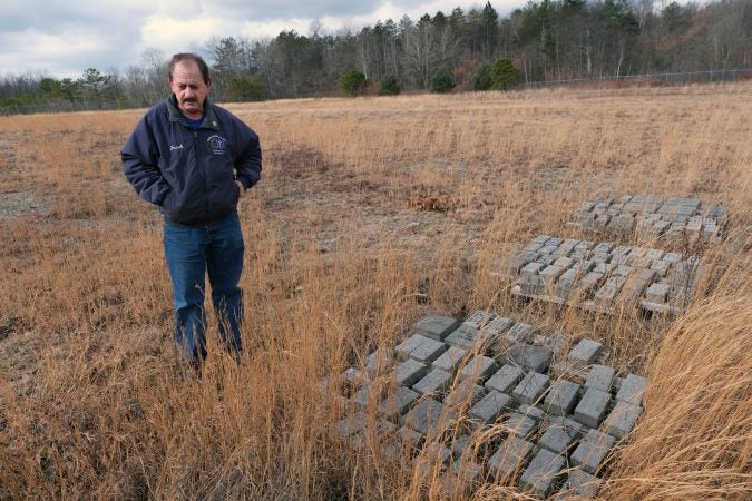 Frank Zangari, with the Schuylkill County Fire Chiefs Association, points out name bricks as he talks about renovations at the Fallen Firefighters Memorial in Frackville, Pennsylvania. (Matt Smith for Keystone Crossroads)