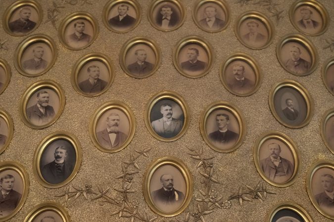 Historical portraits of firefighters are displayed inside the meeting room at American Hose Company No. 2 in Pottsville, Pennsylvania. (Matt Smith for Keystone Crossroads)