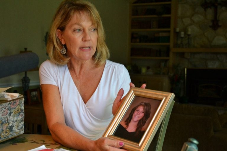 Martha Stringer holds a photo of her daughter, Kim, from when she was in high school. Kim lives with a serious mental illness. Her parents have struggled to get Kim help, because Kim often refuses treatment. (Brett Sholtis / Transforming Health)