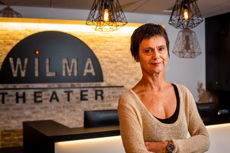 Blanka Zizka stands in front of a Wilma Theater sign