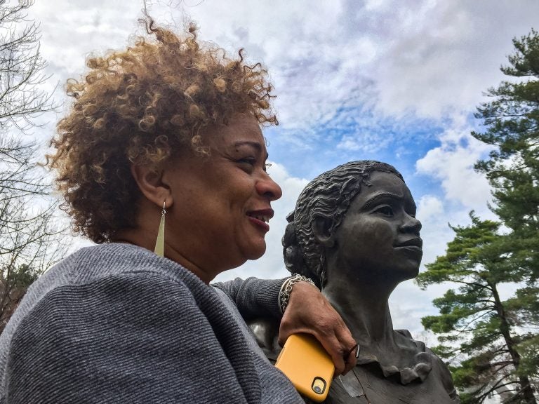 JerriAnne Boggis, executive director of the Black Heritage Trail of New Hampshire, poses with a monument that was erected in Harriet E. Wilson's honor. Boggis says when she read Wilson's book, she felt as if it was written the book just for her. (Verónica G. Cárdenas for NPR)