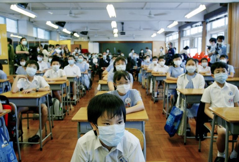 School was suspended for six weeks in Hong Kong as part of the strategy to keep SARS from spreading. On May 12, 2003, primary school children returned to class amid signs that the outbreak was coming under control. (Bobby Yip/Reuters)