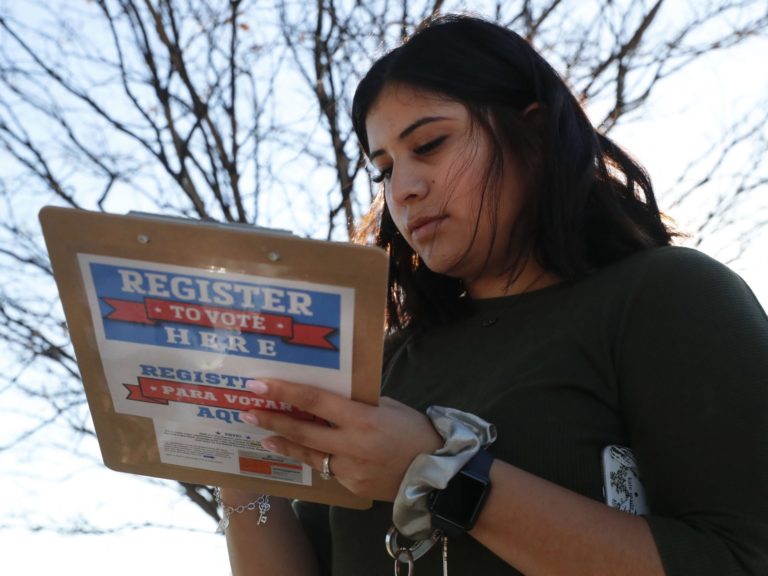 
Karina Shumate, 21, a college student, filled out a voter registration form in Richardson, Texas on Jan. 18. One big registration effort this year has drawn controversy among elections officials. (LM Otero/AP Photo)