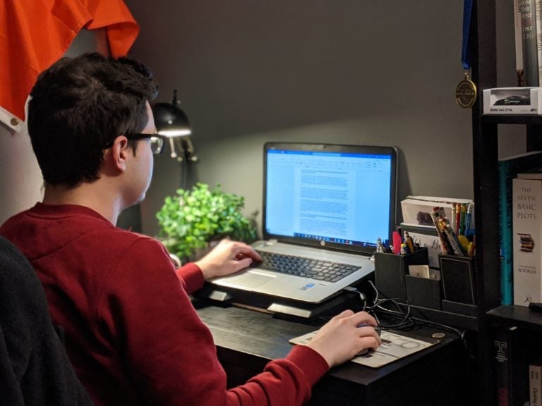 Thomas Duliban working on his laptop. (courtesy of author)