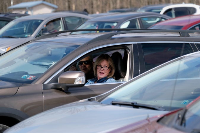 A parishioner sings while in her car during Bethany Wesleyan Church's Sunday worship service at Becky's Drive-In. (Matt Smith for Keystone Crossroads)