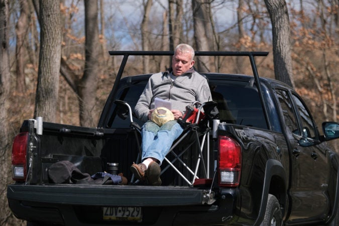 Dean Bardman, of Barto, sits in the bed of his truck during Bethany Wesleyan Church's Sunday worship service at Becky's Drive-In. (Matt Smith for Keystone Crossroads)