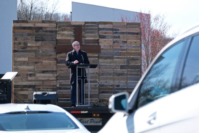 Pastor Kevin Fetterfhoff speaks from in front of the screen during Bethany Wesleyan Church's Sunday worship service at Becky's Drive-In in Walnutport, Pennsylvania. (Matt Smith for Keystone Crossroads)