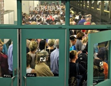 Regional rail passengers pack the platforms at Suburban Station at rush hour on July 5, 2016. (Emma Lee/WHYY)