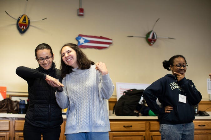 Andria Bibiloni and Laura Beery (left) participate in a warm-up exercise during rehearsal for the play 