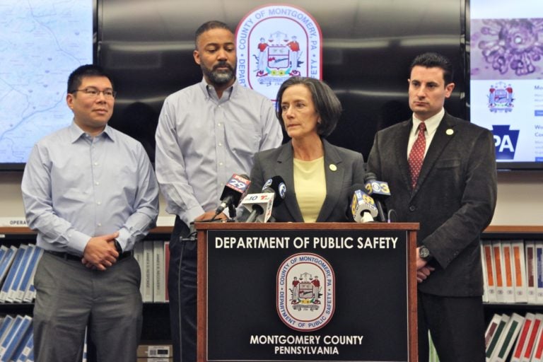 A group of people stand around a podium.