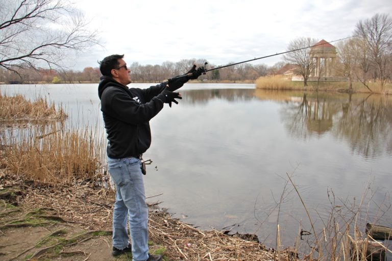 Tony Yoon fishes at Meadow Lake in FDR Park. (Emma Lee/WHYY)