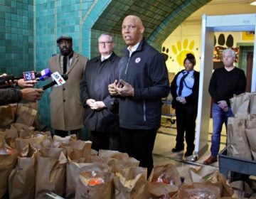 Philadelphia schools Superintendant William Hite (center) is joined by (from left) Councilmember Kenyatta Johnson and Mayor Jim Kenney during a press conference at Tilden Middle School, where hundreds of bagged meals were prepared for students on March 16, 2020. (Emma Lee/WHYY)