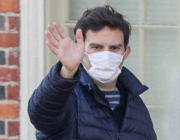 A man walks on Market Street in Wilmington, Del., wearing a protective mask Friday March 27, 2020. (Saquan Stimpson for WHYY)