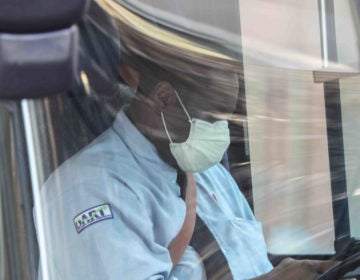 A dart bus driver wears a protective mask while waiting for passengers Friday. March 27, 2020, in Wilmington, Del. (Saquan Stimpson for WHYY)