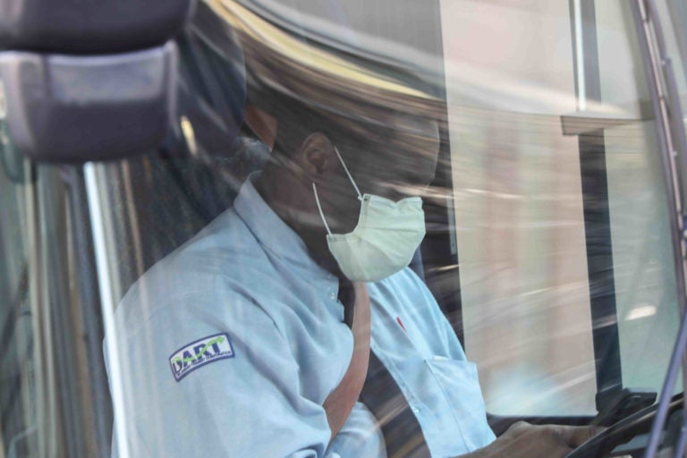 A dart bus driver wears a protective mask while waiting for passengers Friday. March 27, 2020, in Wilmington, Del. (Saquan Stimpson for WHYY)