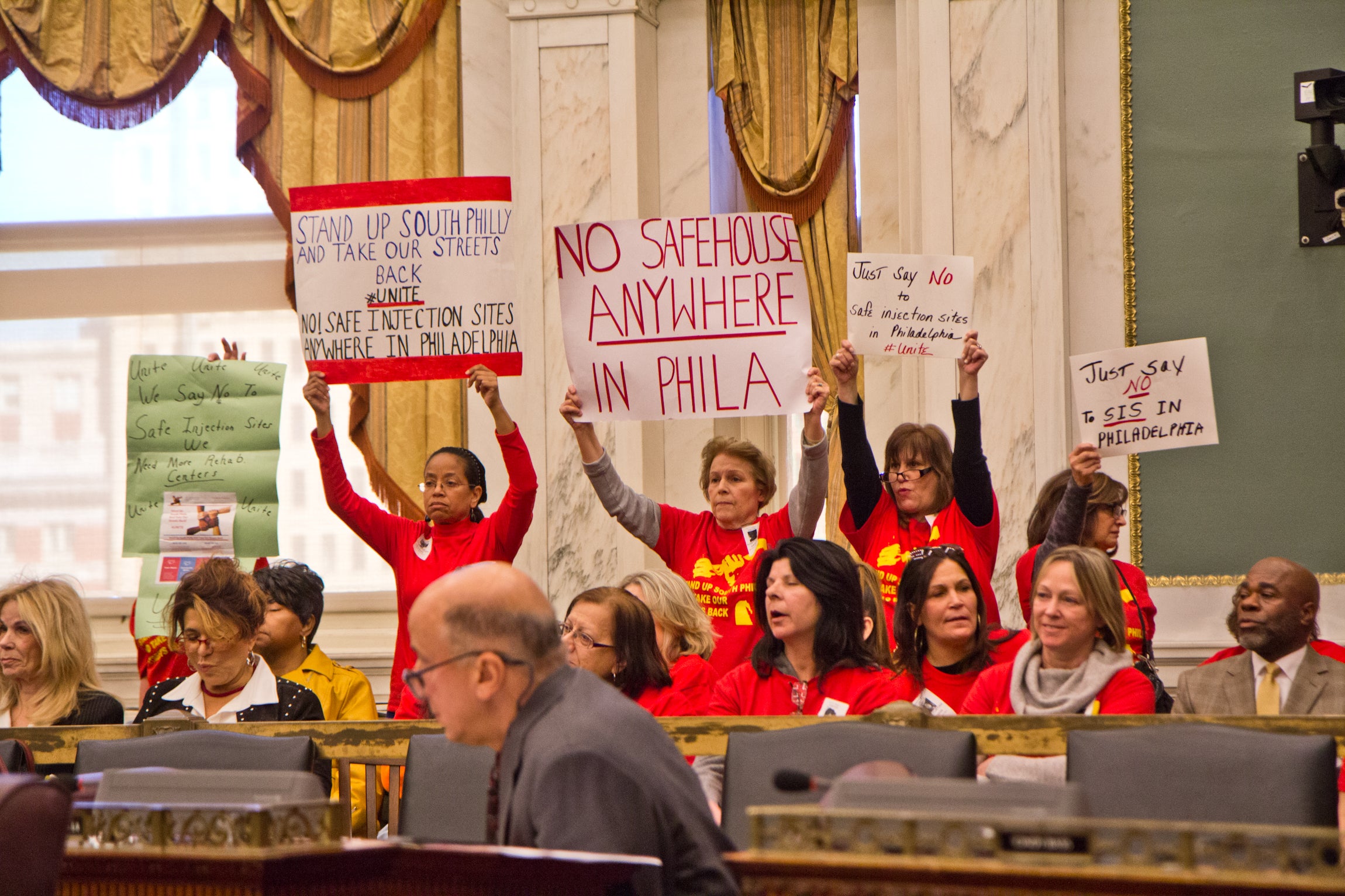 A coalition of South Philadelphia residents cheer opponents of safe injections sites at a hearing in City Council. 