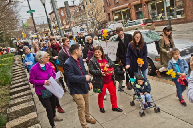 Suyapa Reyes and members of the First United congregation march to the Germantown Mennonite church where Carmela Apolonio Hernandez, another mother living in sanctuary, has called home for the past two years. (Kimberly Paynter/WHYY)