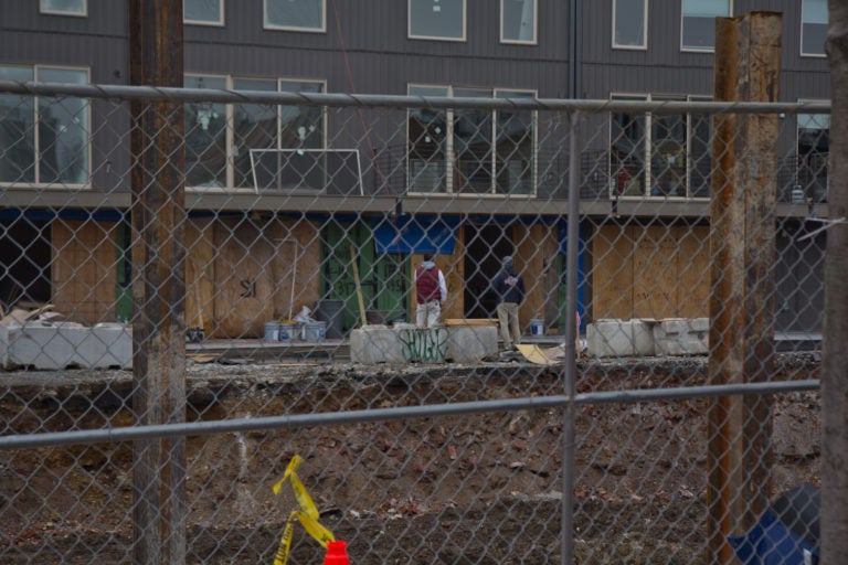 Construction workers on the job at 19th and Reed streets in South Philadelphia in March 2020. (Kimberly Paynter/WHYY)