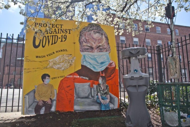 A mural created by artist Nile Livingston was installed at 17th and Vine streets along with a public hand washing station meant for people who are living with housing instability. (Kimberly Paynter/WHYY)