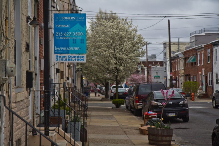 A for sale sign is visible on a street in Fishtown, Philadelphia.