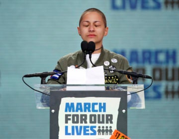 FILE - In this March 24, 2018 file photo, Emma Gonzalez, a survivor of the mass shooting at Marjory Stoneman Douglas High School in Parkland, Fla., closes her eyes and cries as she stands silently at the podium for the amount of time it took the Parkland shooter to go on his killing spree during the 