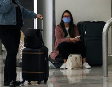 A woman wears protective masks as a precaution against the spread of the new coronavirus at the airport in Mexico City, Friday, Feb. 28, 2020. (Marco Ugarte/AP Photo)