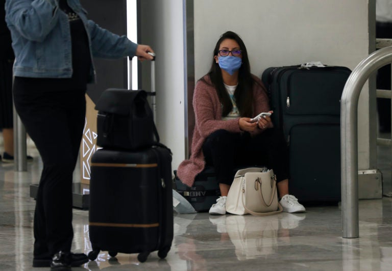 A woman wears protective masks as a precaution against the spread of the new coronavirus at the airport in Mexico City, Friday, Feb. 28, 2020. (Marco Ugarte/AP Photo)