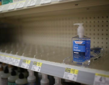 In this Feb. 28, 2020 file photo, rows of hand sanitizer are seen empty at a Walgreens in Idaho Falls, Idaho.  Fear of the coronavirus has led people to stock up on hand sanitizer, leaving store shelves empty and online retailers with sky-high prices set by those trying to profit on the rush. (John Roark/The Idaho Post-Register via AP, file)