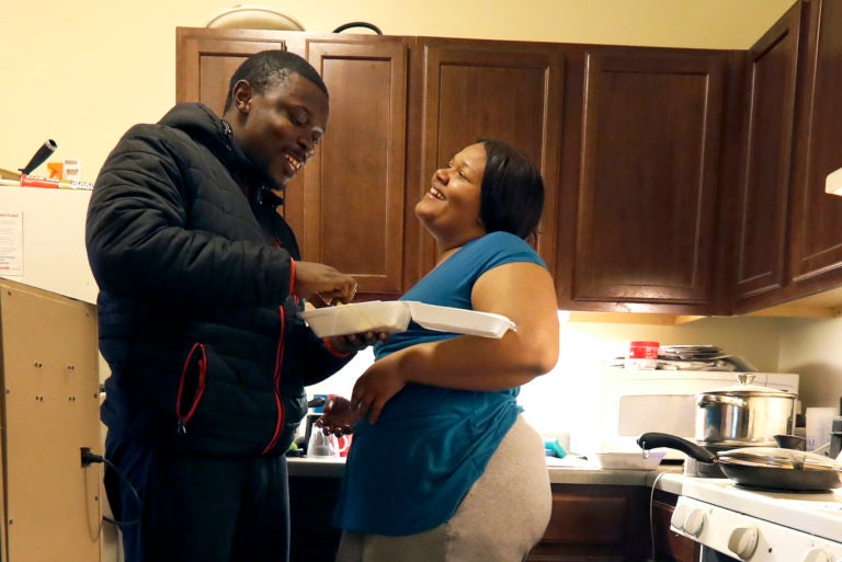 In this Thursday, Feb. 27, 2020, photo, Richard Butler and his fiancé Amber laugh while they have breakfast in an apartment a friend is letting them live in on Chicago’s Southside. (Charles Rex Arbogast/AP Photo)