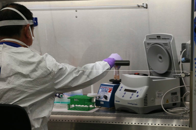 Hawaii state Department of Health microbiologist Mark Nagata demonstrates the process for testing a sample for coronavirus at the department's laboratory in Pearl City, Hawaii. (Audrey McAvoy/AP Photo)