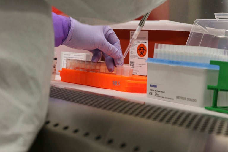 Hawaii state Department of Health microbiologist Mark Nagata demonstrates the process for testing a sample for coronavirus at the department's laboratory in Pearl City, Hawaii on Tuesday, March 3, 2020. (Audrey McAvoy/AP Photo)