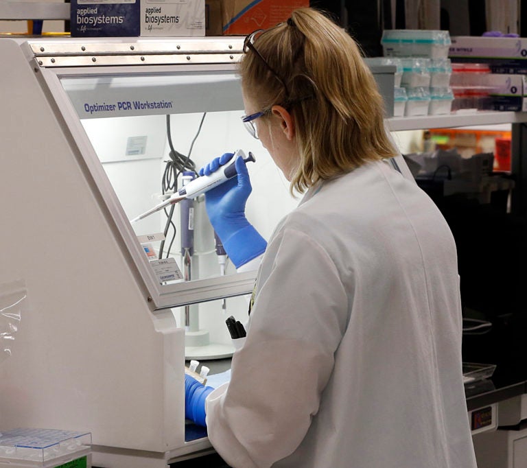 An employee of the Department of General Services Division of Consolidated Laboratories' Virginia Public Health Labratory adds chemicals in the second step of testing a sample for the Coronavirus at the lab in Richmond, Va. on Wednesday, March 4, 2020. ( Joe Mahoney/Richmond Times-Dispatch via AP)