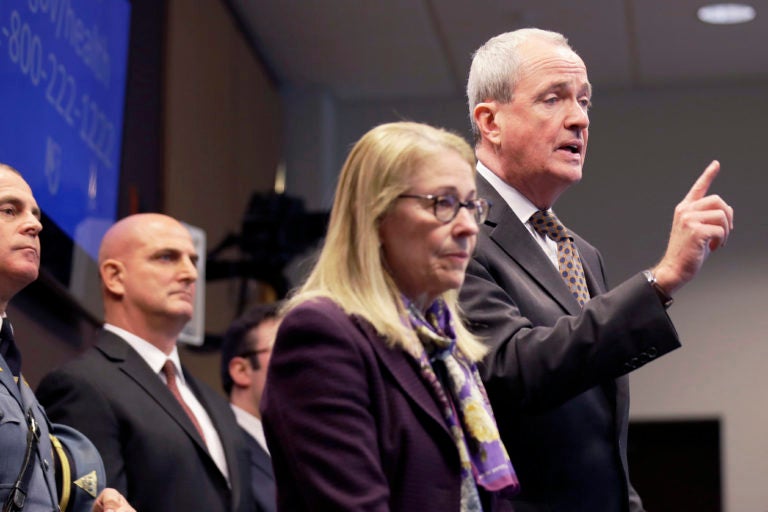 FILE- In this March 2, 2020 file photo, New Jersey Gov. Phil Murphy, right, is joined by Health Commissioner Judith Persichilli, center, during a news conference in Ewing, N.J., Monday, March 2, 2020. On Wednesday, March 4, 2020, Murphy, Persichilli and Acting Governor Sheila Oliver announced the first presumptive positive case of novel coronavirus, or COVID-19, in New Jersey. The individual, a male in his 30s, is hospitalized in Bergen County and has been hospitalized since March 3. (AP Photo/Seth Wenig, File)