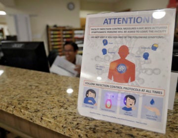 An infection Control Protocol poster sits on a nursing station desk at the Palm Garden of Tampa Health and Rehabilitation Center Thursday, March 5, 2020, in Tampa, Fla. (Chris O'Meara/AP Photo)