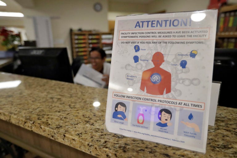 An infection Control Protocol poster sits on a nursing station desk at the Palm Garden of Tampa Health and Rehabilitation Center Thursday, March 5, 2020, in Tampa, Fla. (Chris O'Meara/AP Photo)