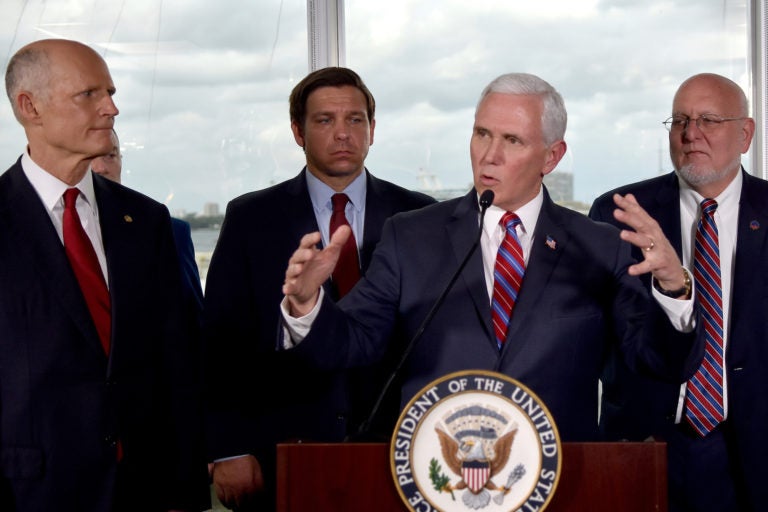 Vice President Mike Pence, center, along with Florida Senator Rick Scott, far left, and Governor Ron DeSantis,left, and CDC Director Dr.Robert Redfield,right, speaks to the media in Fort Lauderdale, Fla. (Gaston De CardenasAP Photo)