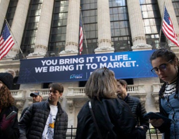 In this Monday, March 9, 2020 file photo, people stop to look at the New York Stock Exchange. Stocks are opening sharply lower on Wall Street Wednesday as fears of economic fallout from the coronavirus outbreak grip markets again.  (Mark Lennihan/AP Photo)