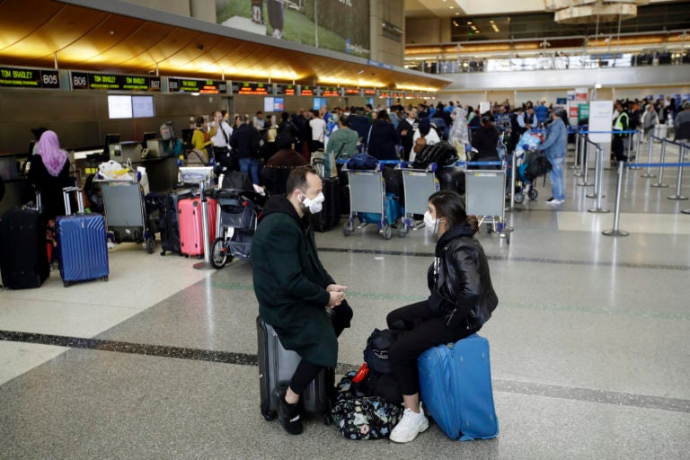 Travelers wait to check in their luggage at the Los Angeles International Airport Saturday, March 14, 2020, in Los Angeles. The coronavirus outbreak is hitting the airline industry hard. President Trump banned most Europeans from entering the United States for 30 days to try to slow down the spread of the virus. The new travel ban is likely to further roil the airline industry as bookings decline and people cancel reservations out of fear they might contract the virus.(AP Photo/Marcio Jose Sanchez)