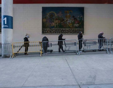 New Jersey joined with New York and Connecticut to close bars, restaurants and movie theaters starting Monday night. Here, customers wait in line at a store in New York. (Yuki Iwamura/AP Photo)