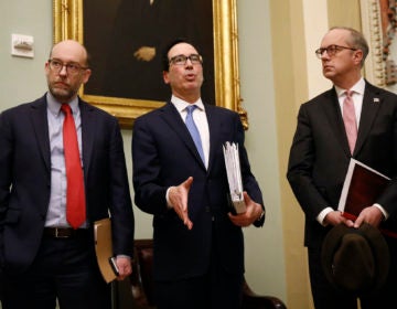 Treasury Secretary Steve Mnuchin, center, speaks with members of the media as he departs a meeting with Senate Republicans on an economic lifeline for Americans affected by the coronavirus outbreak. on Capitol Hill in Washington, Monday, March 16, 2020. (Patrick Semansky/AP Photo)
